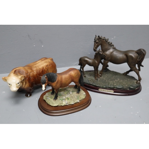 325 - Three Figures including two Horses mounted on Wooden Plinths and a Vintage Bull