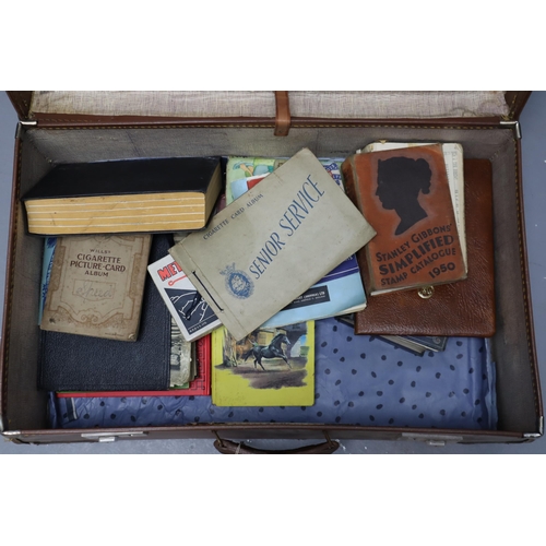 881 - Vintage suitcase with a selection of vintage books, cigarette cards, tins and others