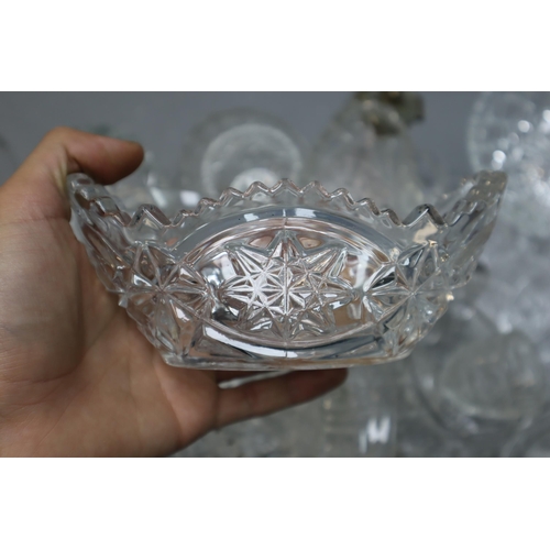 886 - A Large Selection of Cut Crystal Ware. Includes Vases, Drinking Glasses, Bowls and More