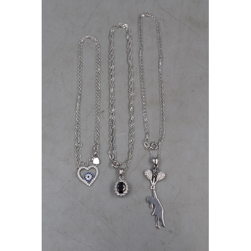 34 - Three Silver 925 Necklaces to include Girl with Balloons, Black Stoned Pendant and a Diamanté... 