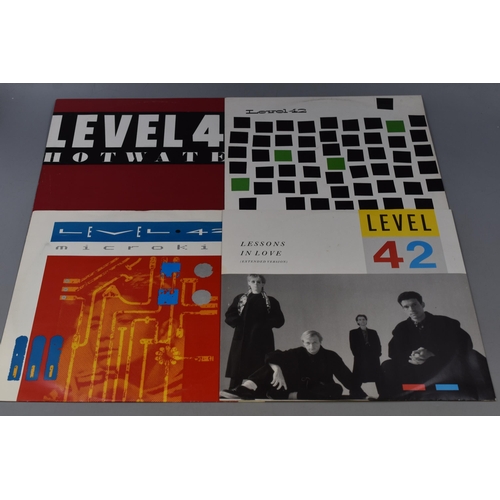 568 - A Selection of Level 42 Vinyls (LP's and Singles) and A Tour Programme. Includes World Machine, Runn... 