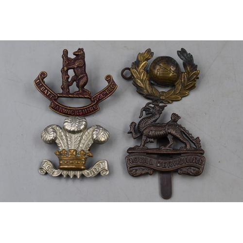 269 - Four Military Cap Badges to include Royal Berkshire, Warwickshire, Fleur-De-Lis and Old Europe