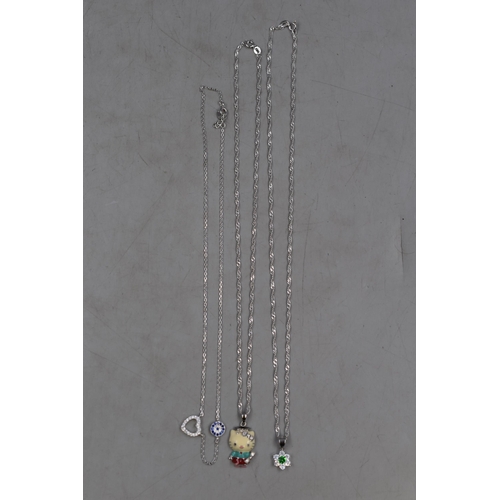 15 - Three Silver 925 Necklaces to include Hello Kitty Style, Flower with Green Stone and Diamanté... 