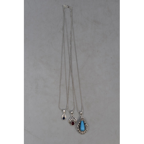 60 - Three Silver 925 Pendant Necklaces on Silver 925 Chains. Includes Floral Blue Stone Design and Red a... 