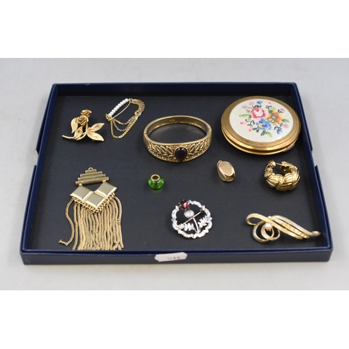 150 - Selection of ladies jewellery to include MIZPAH thistle brooch, petit point compact, Avon bracelet a... 