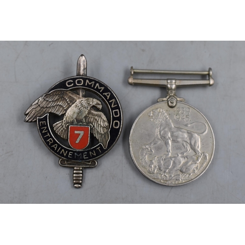 303 - Two Military Badges To Include 1939-45 Medal, And French Commando Badge