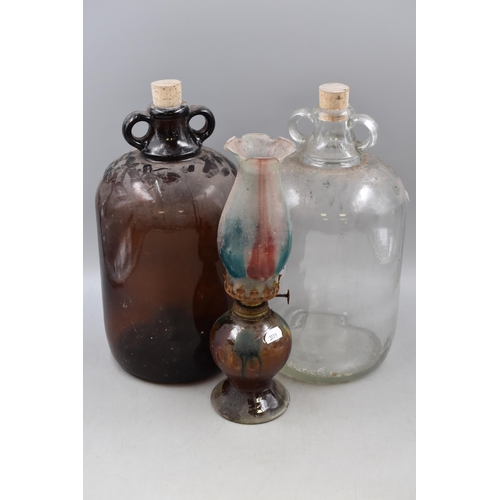 848 - Two Glass Demijohns, With a Vintage Oil Lamp. Approx 13