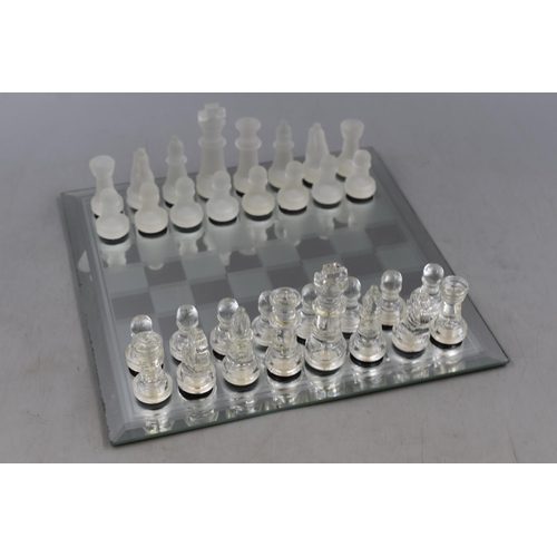 653 - A Complete Chess Set With Glass Pieces and Mirrored Board. Board is Approx 10