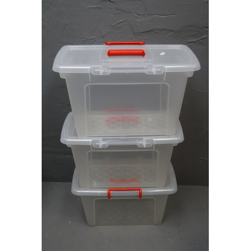 772 - Three plastic storage containers with lids measring 18