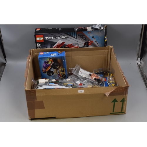 906 - A Box of Assorted Lego Pieces To Include Ducati Model (Unchecked), Lego City Set (Unchecked), And Mo... 