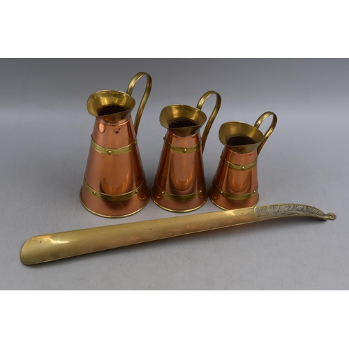 306 - A Set of Three Graduating Copper and Brass Jugs, With a Brass Shoe Horn. Shoe Horn is Approx 16