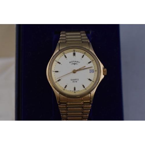 86 - A Gold Tone Rotary Quartz Day/Time Watch, In Presentation Box With Paperwork. Working