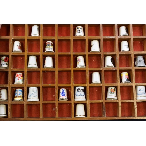 323 - Thimble Display unit Complete with a collection of thimbles approx 16