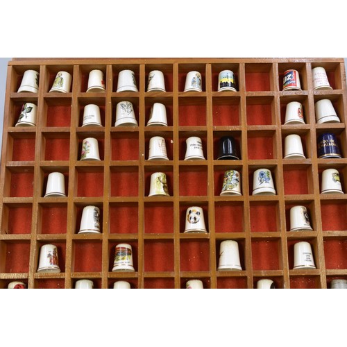 323 - Thimble Display unit Complete with a collection of thimbles approx 16