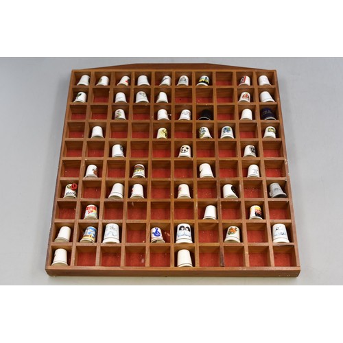 323 - Thimble Display unit Complete with a collection of thimbles approx 16