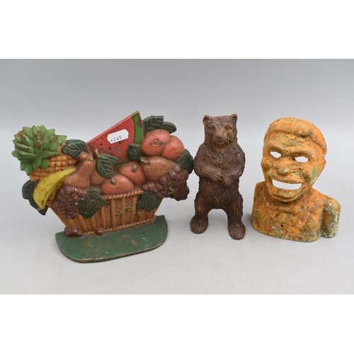 335 - A Selection of Cast Iron Items. Includes Fruit Basket Doorstop, Bear Moneybox Front, And Jolly Man M... 