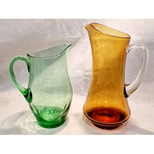 264 - Two Coloured Glass Pitchers Amber 1 is 11.5 inches tall , Green is 9.5 inches tall.