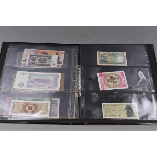 267 - Folder Containing a Selection of Uncirculated Worldwide Bank Notes. Includes Venezuela, Vietnam, Leb... 