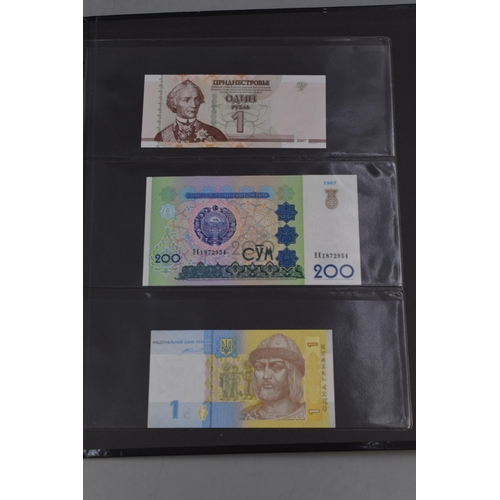 270 - Folder Containing a Large Selection of Uncirculated Worldwide Banknotes. Includes Ukraine, Mongolia,... 