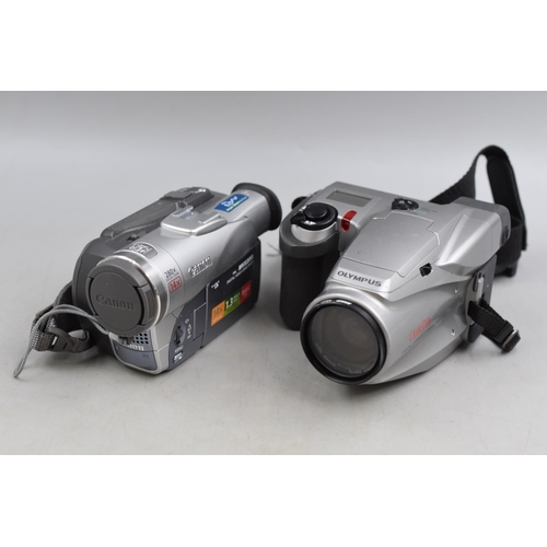 594 - Two items includes Canon Digital Camcorder in Box and a Camedia Camcorder (Both Untested)