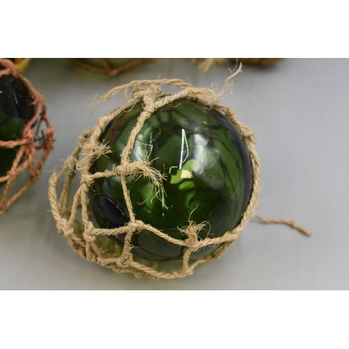 740 - A Selection of Five Netted Glass Fishing Buoys