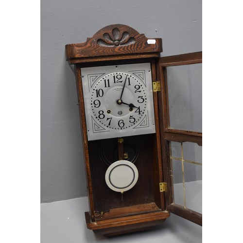 397 - A Boa Reguladora Portuguese wall clock with leaded glass, pendulum and key measures 26