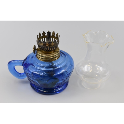 318 - Two items to include Unusual Eden Project Blue Vase (7”) and a Small Paraffin Lamp