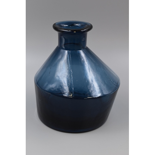 318 - Two items to include Unusual Eden Project Blue Vase (7”) and a Small Paraffin Lamp