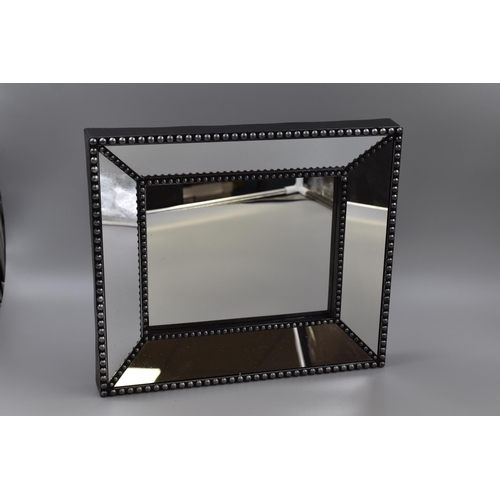 628 - Two deep frame black and silver mirrors measuring 15