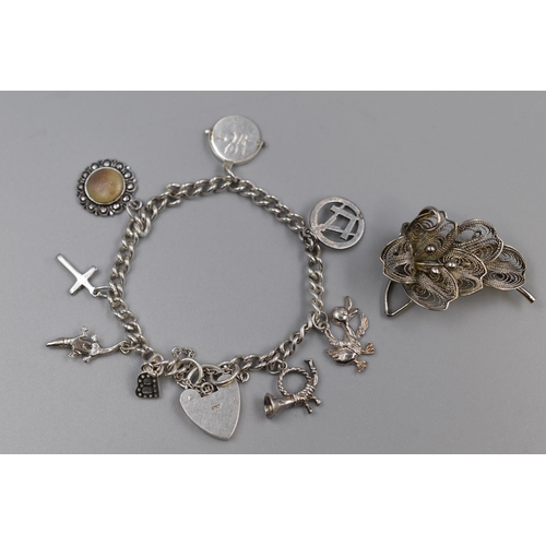 65 - Two Silver items to include Charm Bracelet and a Filigree Brooch