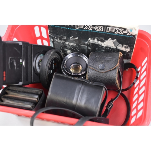 625 - A Yashica FX-2 Film Camera, With Accessories. Includes Four Lenses, Filters, And Flash Unit