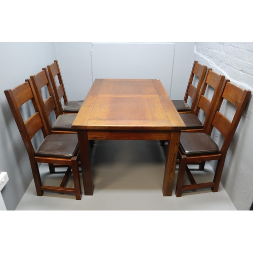 642 - Dark hardwood extending dining table with six chairs, measures 60