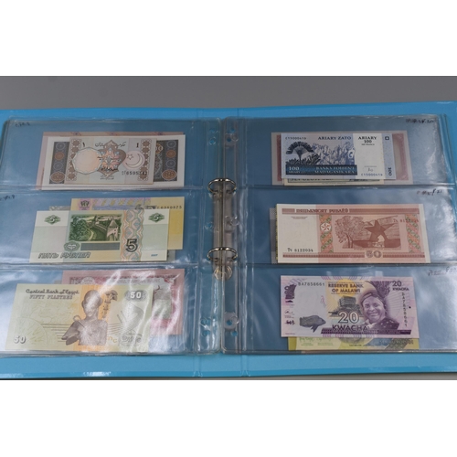 200 - Folder Containing a Large Selection of Uncirculated Worldwide Bank Notes. Includes Zambia, Lebanon, ... 