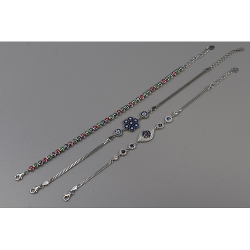 43 - Three Silver 925 Diamanté Bracelets, includes Evil Eye Design and Blue Snowflake Design. Comp... 