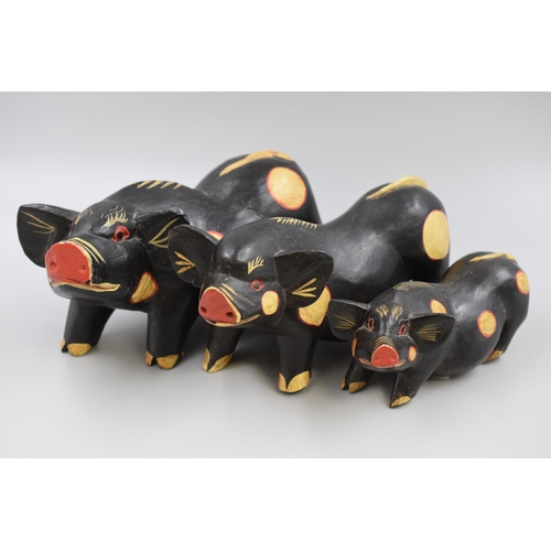 262 - Three Graduating Black Wooden Pig Ornaments (Largest 9” x 5”)