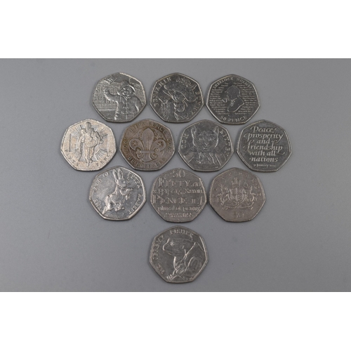 117 - Eleven Collectable Fifty Pence Coins to include Victoria Cross, Peter Rabbit and more