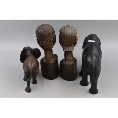 221 - Four Pieces of Tribal Art. Includes Two Wooden Handcarved Busts, Handcarved Elephant, And Ceramic El... 