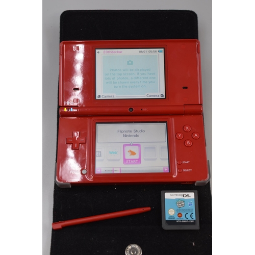 355 - A Nintendo DSi in Crimson, With Case, Family Game Night, Charger and Power Pack. Powers on When Test... 