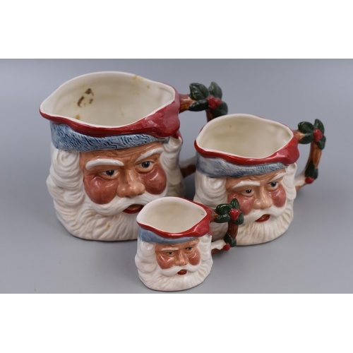 382 - A collection of three Kelsboro ware Father Christmas character jugs largest 4