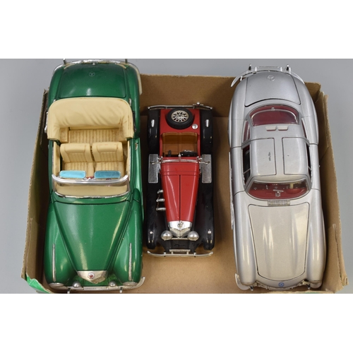 562 - Three Mercedes die cast cars to include 1/18 scale 1955 300S convertable in green, 1/18 scale 1955 3... 