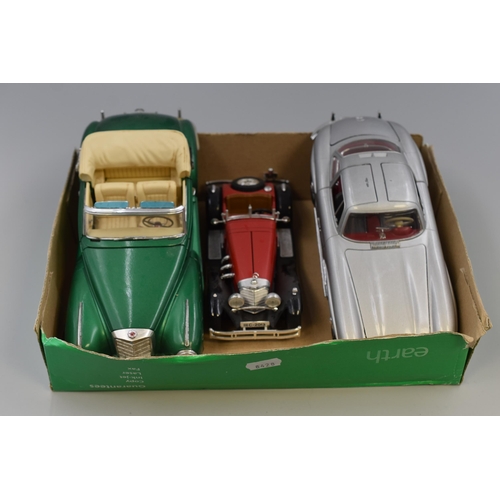 562 - Three Mercedes die cast cars to include 1/18 scale 1955 300S convertable in green, 1/18 scale 1955 3... 