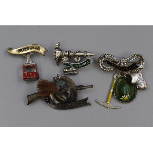 268 - A selection of four German/Austrian climbing brooches.