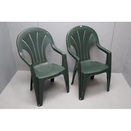 618 - Two green outdoor plastic garden chairs