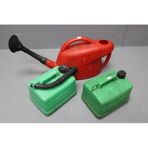 685 - Red plastic watering can and two 5 litre green petrol cans.