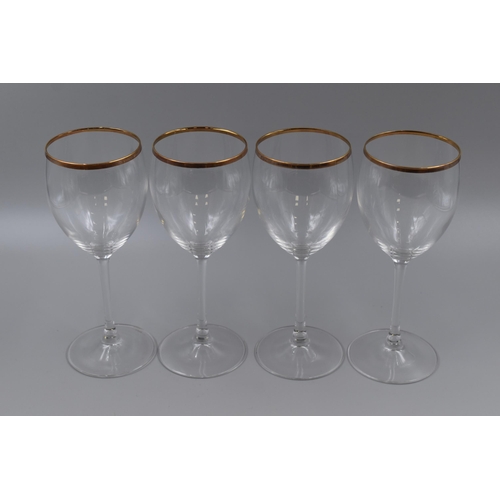 330 - Four long stemmed wine glasses with gold rims, standing 8