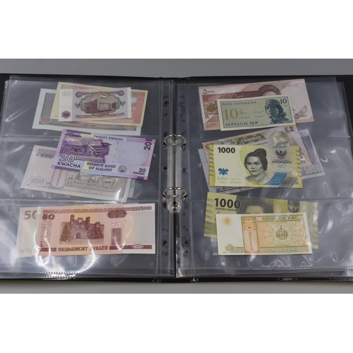 223 - Folder Containing a Large Selection of Uncirculated Worldwide Banknotes. Includes Laos, Congo, Malaw... 