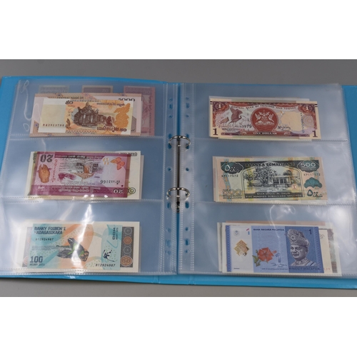 224 - Folder Containing a Large Selection of Uncirculated Worldwide Banknotes. Includes Indonesia, Ukraine... 