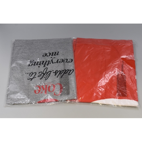 563 - Two Coca-Cola Official Merchandise T Shirts (Size M & L)