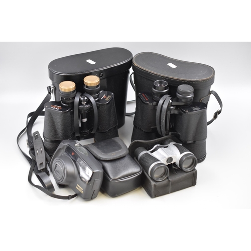 581 - Three Pairs of Binoculars and Pentax Camera To Include Prinz 10x50, Tecnar By Swift 7x50, And Others