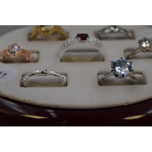 32 - Seven Modern Designer Rings. Includes Clear Stoned, Red Stoned, Gold Tone Amber Stoned and More
